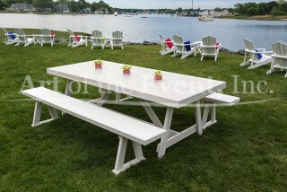 white picnic table along the water