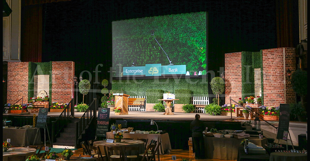 Stage decorated with brick and fake plants